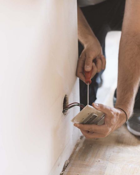 Professional electrician, installing sockets at home