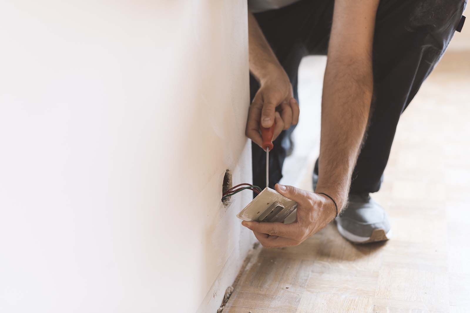 Professional electrician, installing sockets at home